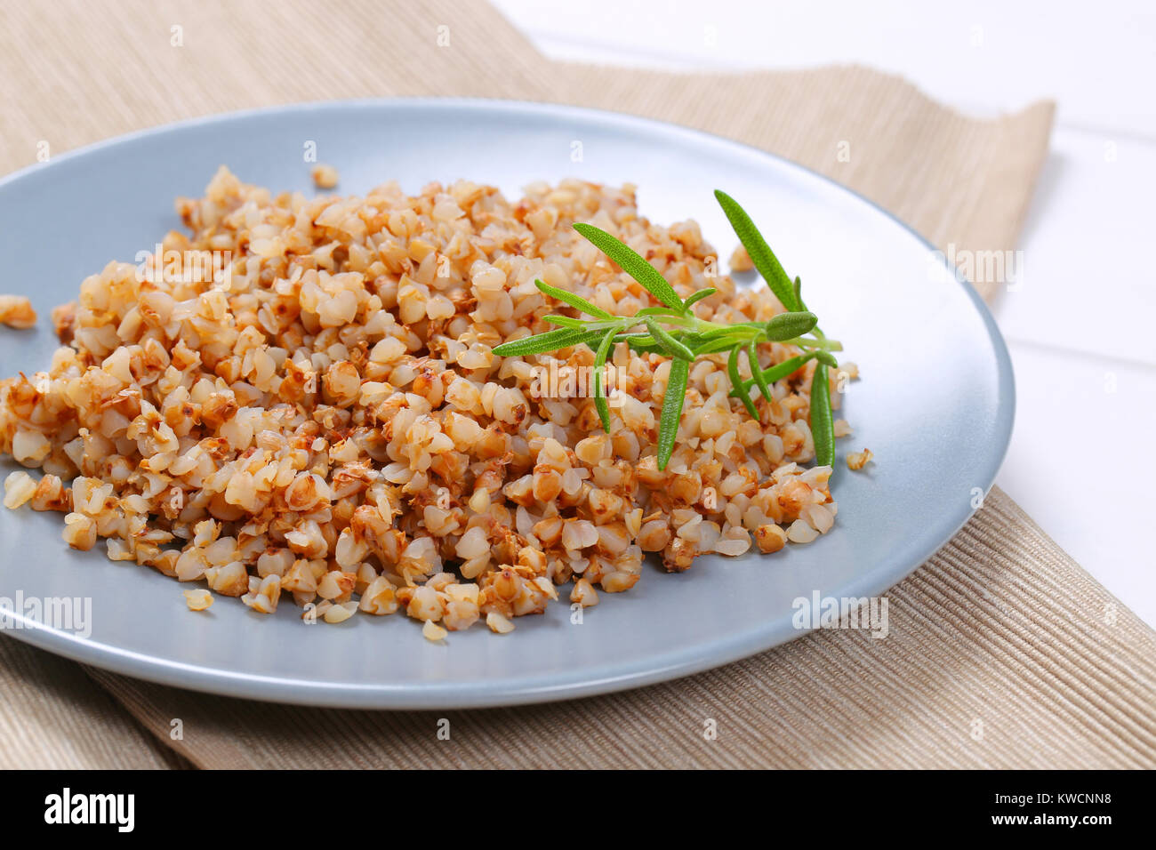 plate of cooked buckwheat on beige place mat - close up Stock Photo