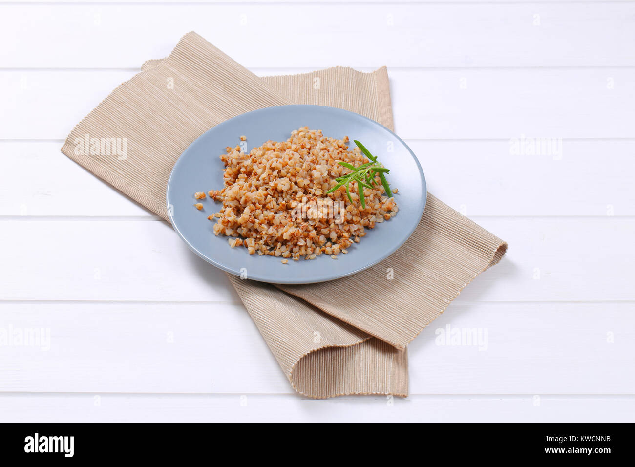 plate of cooked buckwheat on beige place mat Stock Photo