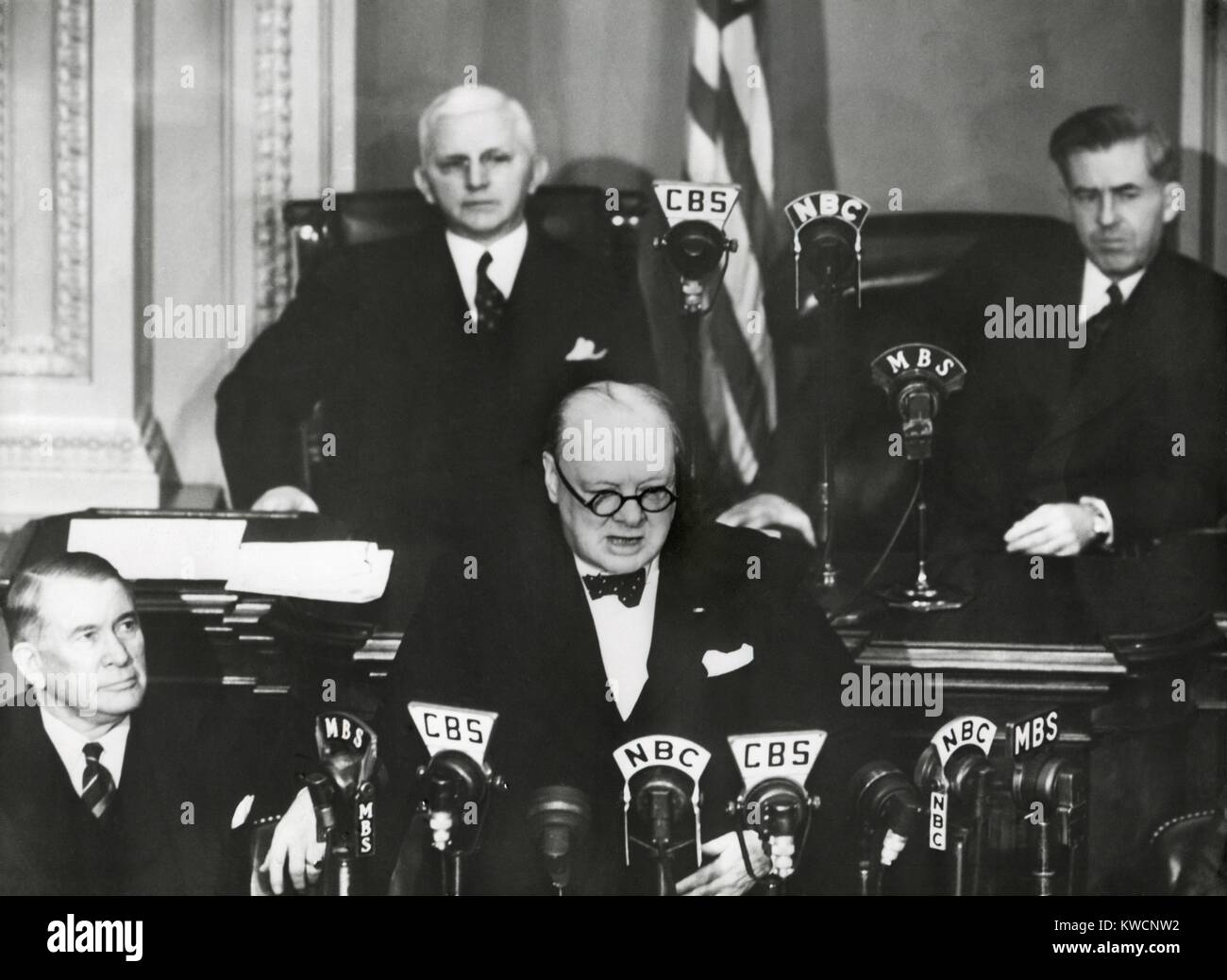 Prime Minister Winston Churchill speaking to a joint session of Congress, Dec. 26, 1941. Less than 3 weeks after the Japanese Attack on Pearl Harbor, Churchill visited the U.S. to strengthen the British-U.S. alliance. Behind him on the Rostrum, L-R: Rep. William Cole, Vice President Henry Wallace. At Lower left is Sen Alben Barkley, Majority Leader. - (BSLOC 2014 17 36) Stock Photo