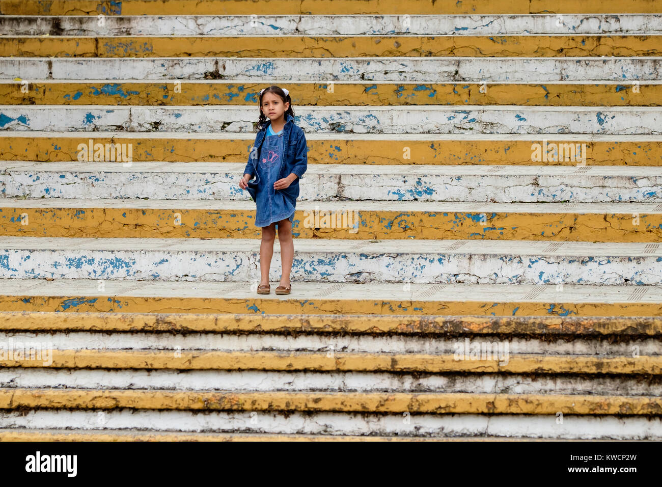 A girl standing on the steps of the The Guadalupe Church in San Cristóbal de Las Casas, Mexico Stock Photo