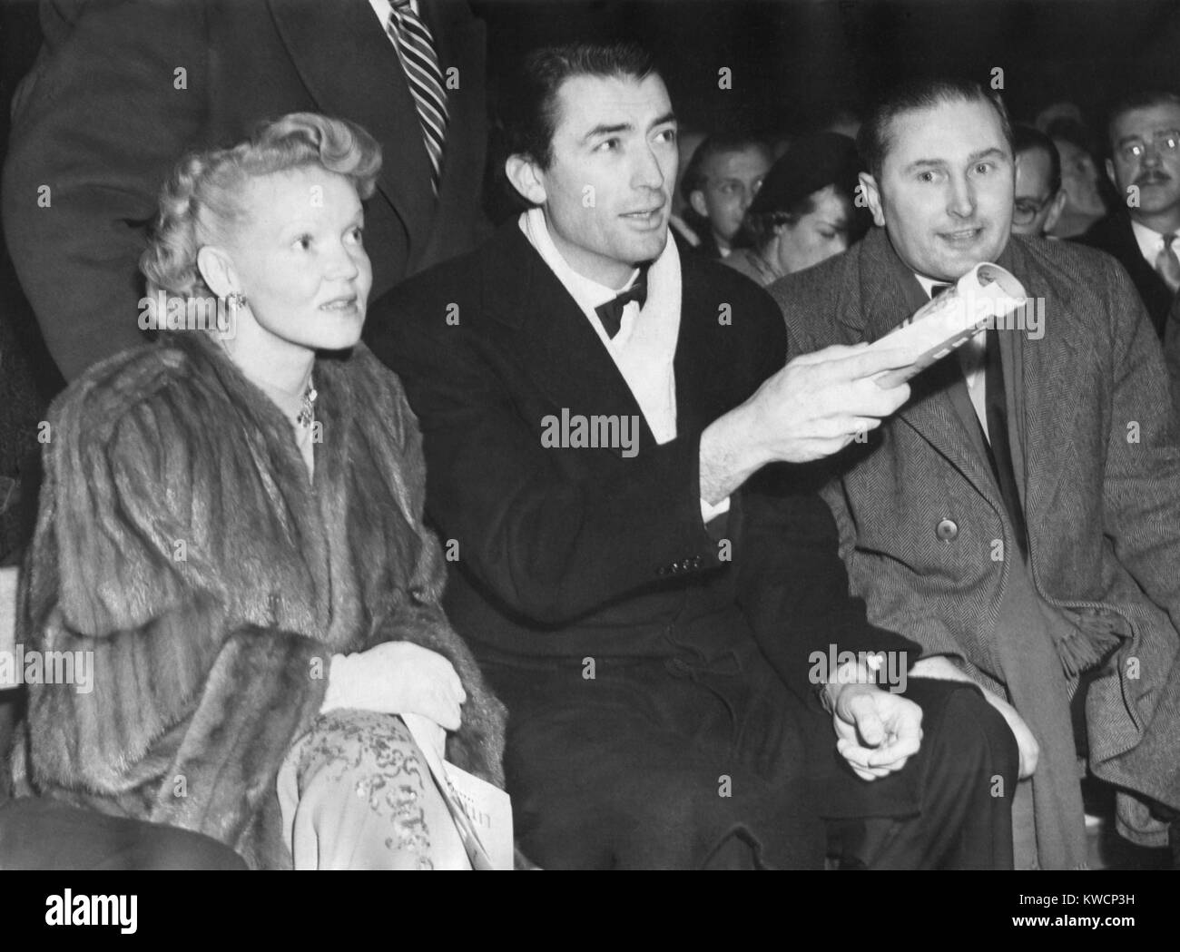 Actor Gregory Peck and his wife, Greta Kukkonen, at the Maxim-Mills title fight. Jan 24, 1950. World Heavyweight holder Freddie Mills and Challenger Joey Maxia of America boxed at Earl's Court, London. Joey Maxia won the bout. - (BSLOC 2014 17 84) Stock Photo