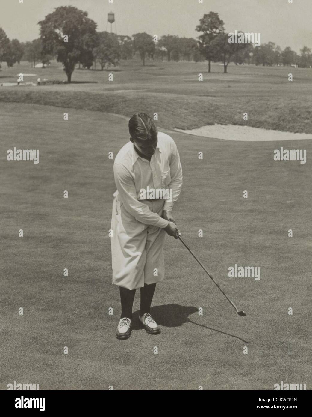 Bobby Jones, winner of 1929 National Open Golf Championship. He is sinking a putt with his famous putter, 'Calamity Jane'. - (BSLOC_2015_1_121) Stock Photo