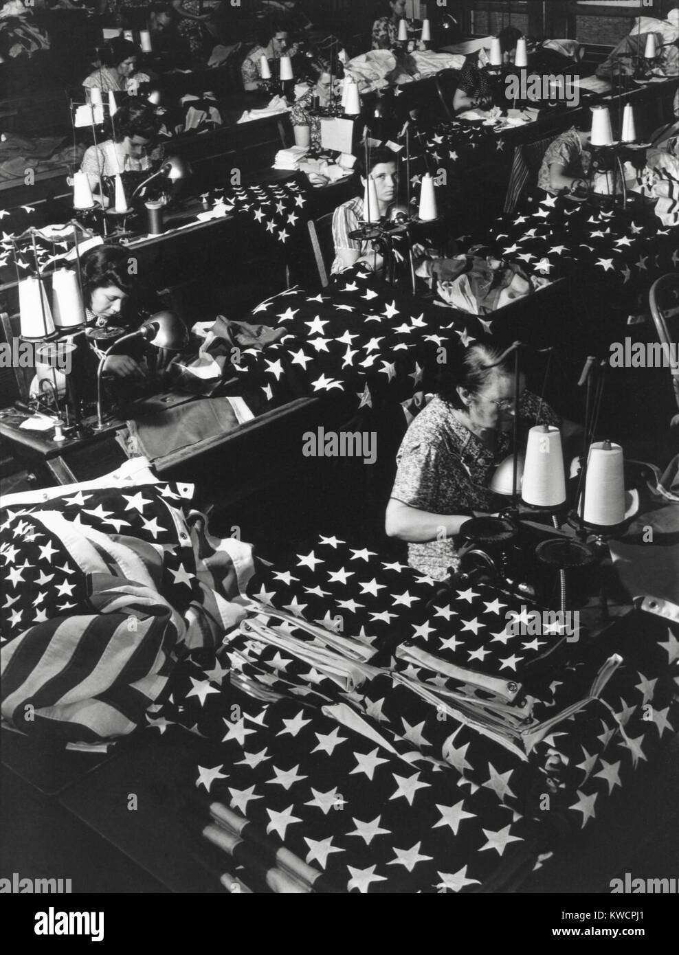 Women sewing American Flags in Brooklyn, New York City on July 24, 1940. Photo from the Records of Naval Districts and Shore Establishments, by Margaret Bourke-White. - (BSLOC 2015 1 196) Stock Photo
