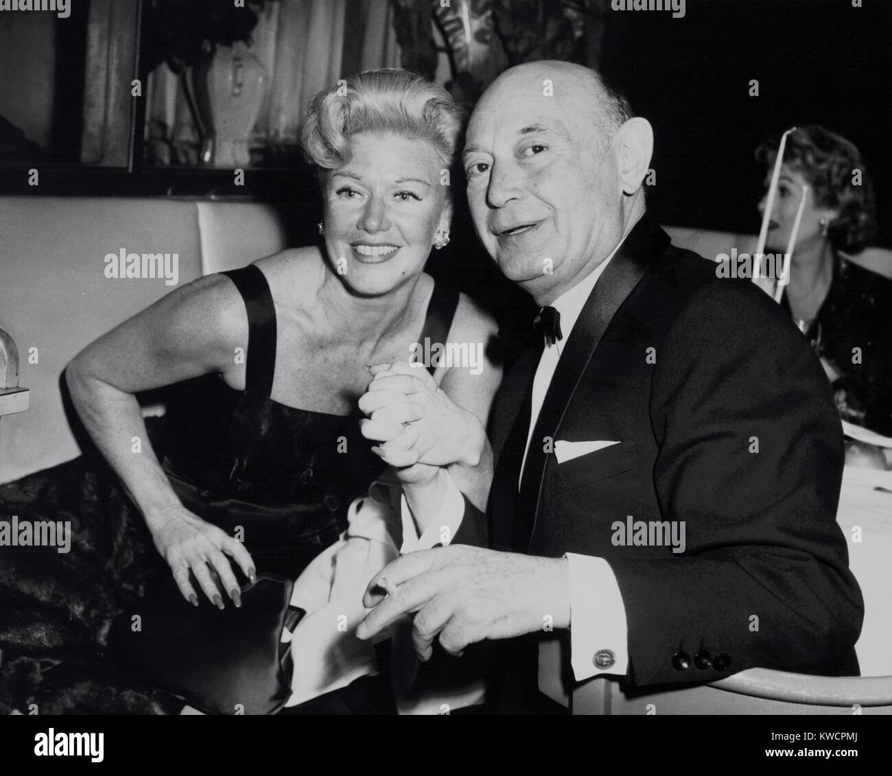 Boris Morros posing with Ginger Rogers at the Harwyn Club in NYC, Nov. 13, 1957. Morros, a Hollywood producer, was spied for the Soviets during World War 2, and became a double agent for the FBI in 1947. Morros was the co-author of the screenplay for the 1960 film, MAN ON A STRING, starring Ernest Borgnine and based on Morros espionage experiences. - (BSLOC 2015 1 21) Stock Photo