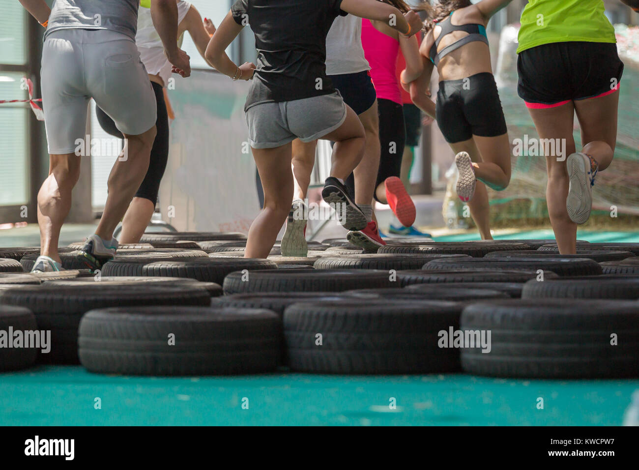 Running On Rim People Running over the Tyre During Fitness Obstacle Exercise Stock ...