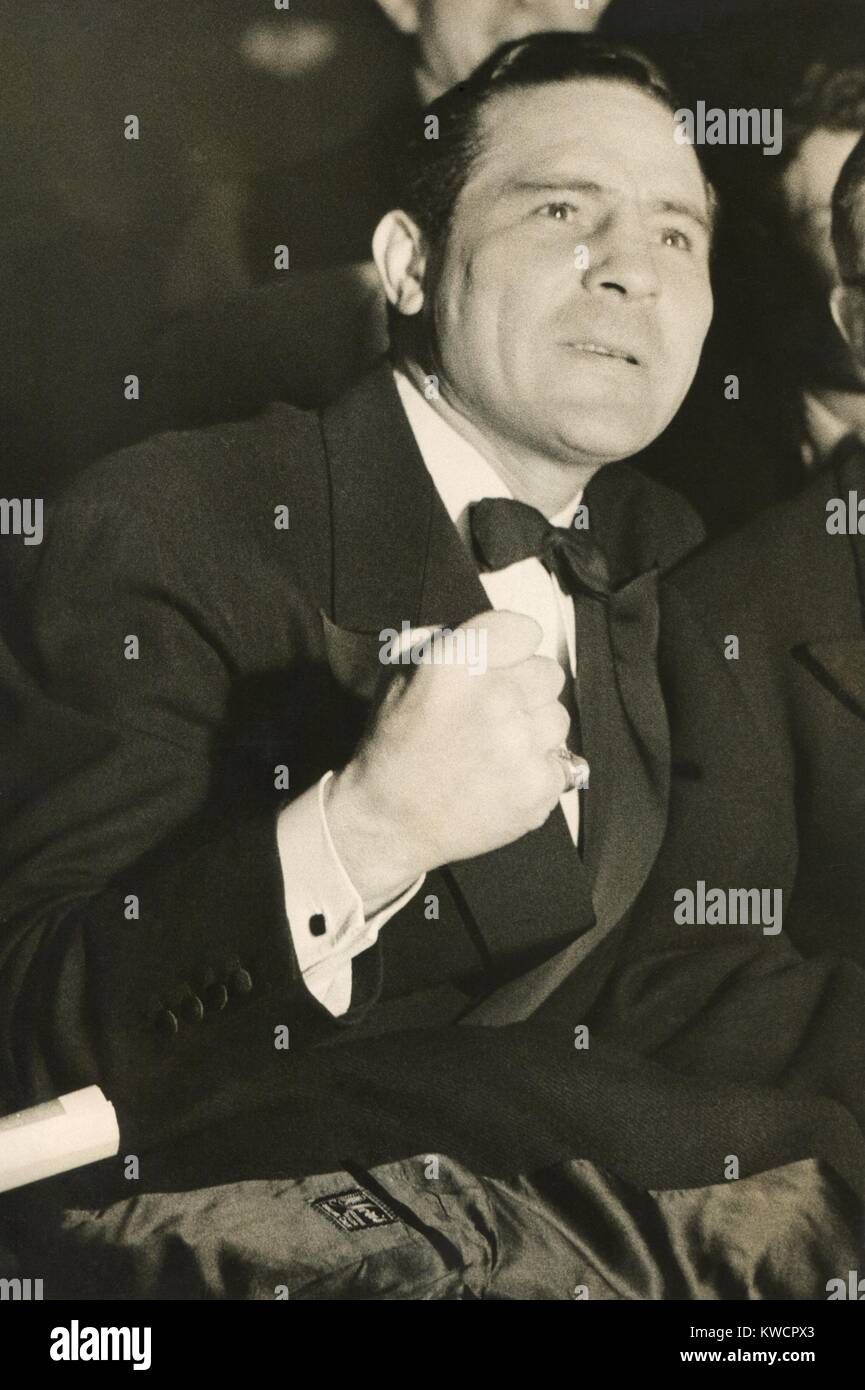 Max Baer watches the Ben Foord-Tommy Farr boxing match of March 3, 1937, with intense interest. He was scheduled to fight Farr the following month in the same ring at Harringay Arena, London. - (BSLOC 2014 17 150) Stock Photo