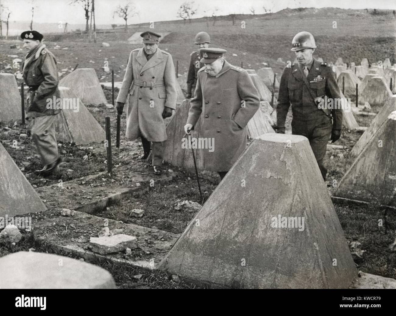 Churchill and Commanders visit the Western Front on March 4, 1945. Winston Churchill walked in the 'dragon's teeth' of the Siegfried Line near Aachen, with him, L-R: Field Marshall Montgomery, Sir Allen Brooke, unidentified U.S. Officer, Churchill, and Lt. General William Simpson of 9th American Army. - (BSLOC 2014 17 39) Stock Photo