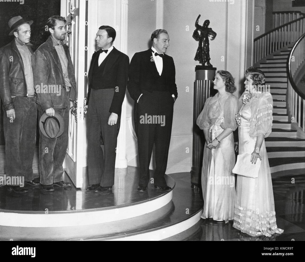 Three Hollywood actors with their Stand-Ins during the production of 'Merrily We Live'. Feb.10, 1938. L-R: George Flynn, Brian Aherne, Bud Carpenter, Alan Mowbray, Georgia Bonafeld, Billie Burke. Stand-ins take the actors place during the lighting of the set and focusing the camera. - (BSLOC 2014 17 73) Stock Photo