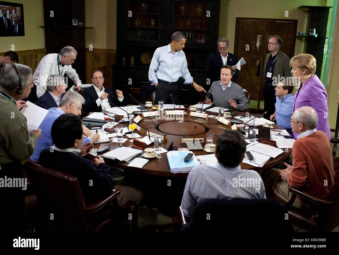 Barack Obama hosts a G8 Summit working session in the dining room of Laurel Cabin at Camp David. Seated facing camera, L-R: Francois Hollande of France; PM David Cameron of Britain; PM Dmitry Medvedev of Russia, (standing) Angela Merkel of Germany. (BSLOC_2015_3_165) Stock Photo