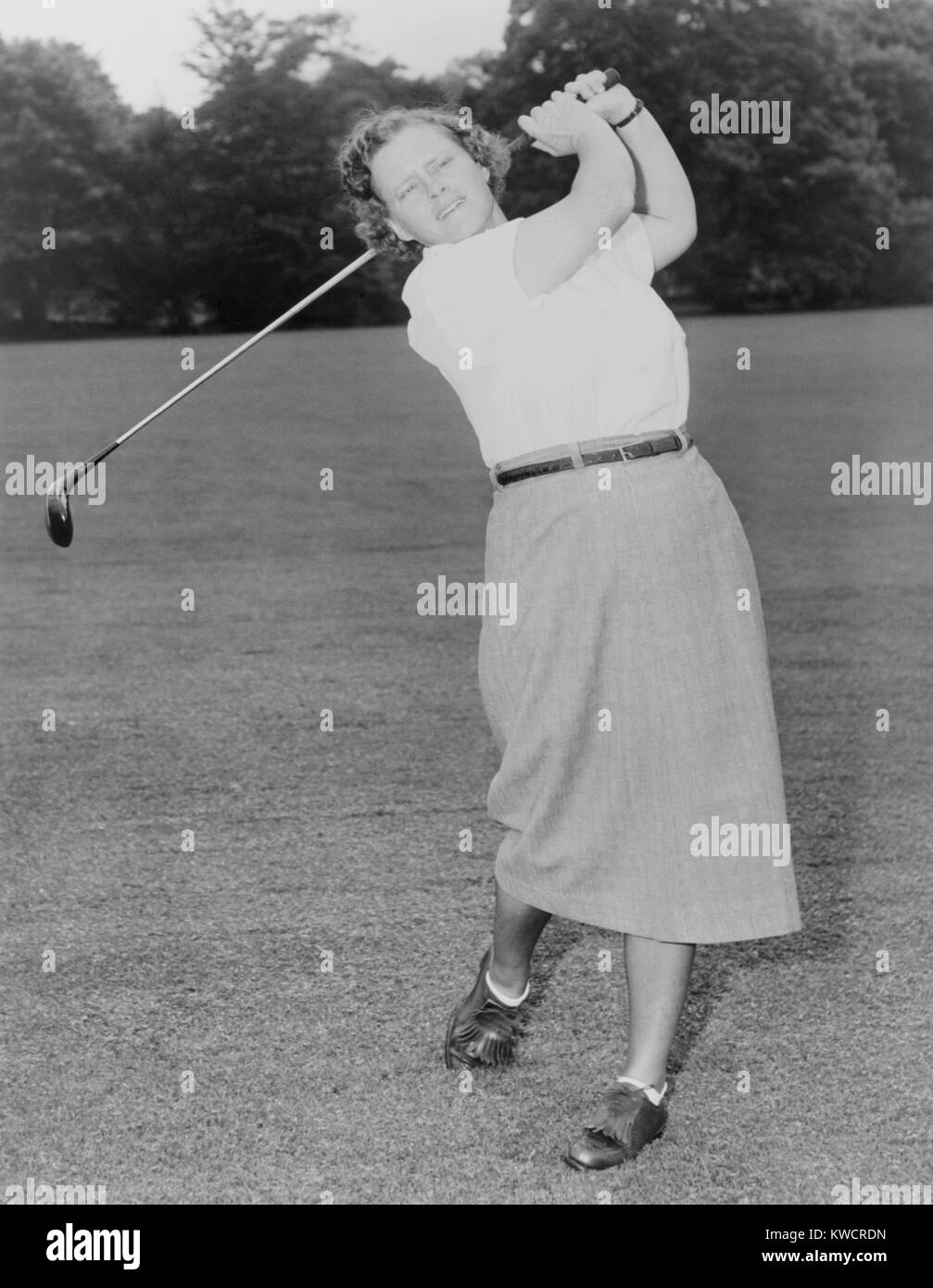 Patty Berg playing golf in 1951. She was a founding member and player on the LPGA Tour. She won 15 major titles from 1940 to 1962. - (BSLOC 2015 1 120) Stock Photo