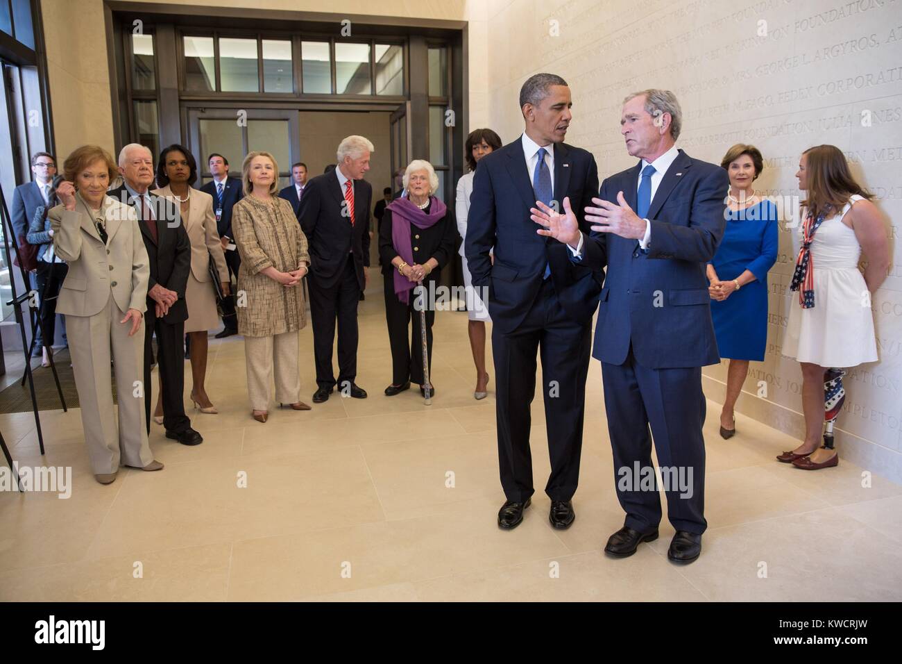 President Barack Obama talks with former President George W. Bush, April 25, 2013. At far right is Melissa Stockwell, the first female US soldier to lose a limb in Iraq. Condoleezza Rice stands between Jimmy Carter and Hillary Clinton (BSLOC 2015 3 54) Stock Photo