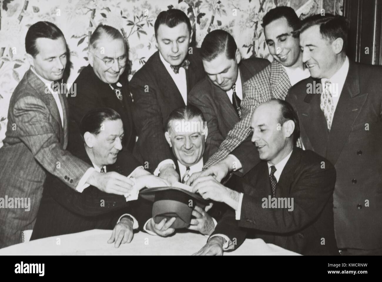 NFL owners gather around Commissioner Bert Bell for the annual bonus draft, Jan. 18, 1951. Standing L-R: Dan Reeves, Los Angeles; Emil Fischer, Green Bay; John Michelosen, Pittsburgh; John Mara, New York Giants; Tony Morabito, San Francisco; and Norman Strader, New York. Seated, L-R: Ray Bennigsen, Chicago Cardinals; Bert Bell; and Paul Brown, Cleveland. - (BSLOC 2015 1 216) Stock Photo