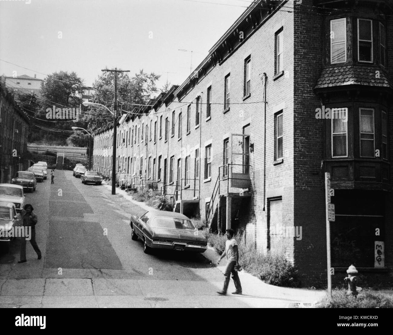 Yonkers, New York, ca. 1980. Moquette Row Housing, built in the 1880s, with each individual house, approximately 17 - 20 feet wide. Row North and South, view west showing front elevation with original end structures. Westchester County, NY. (BSLOC 2015 11 11) Stock Photo