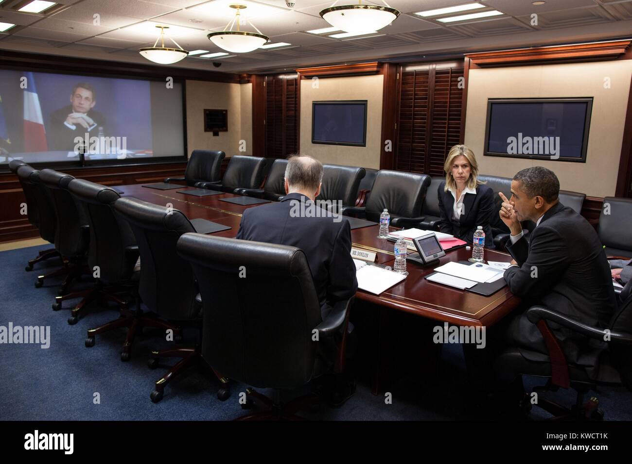 President Barack Obama in a video teleconference with President Nicolas Sarkozy of France. With the President in the Situation Room of the White House are National Security Advisor Tom Donilon and Sr. Dir. For European Affairs, Liz Sherwood-Randall. April 12, 2012. (BSLOC 2015 3 164) Stock Photo
