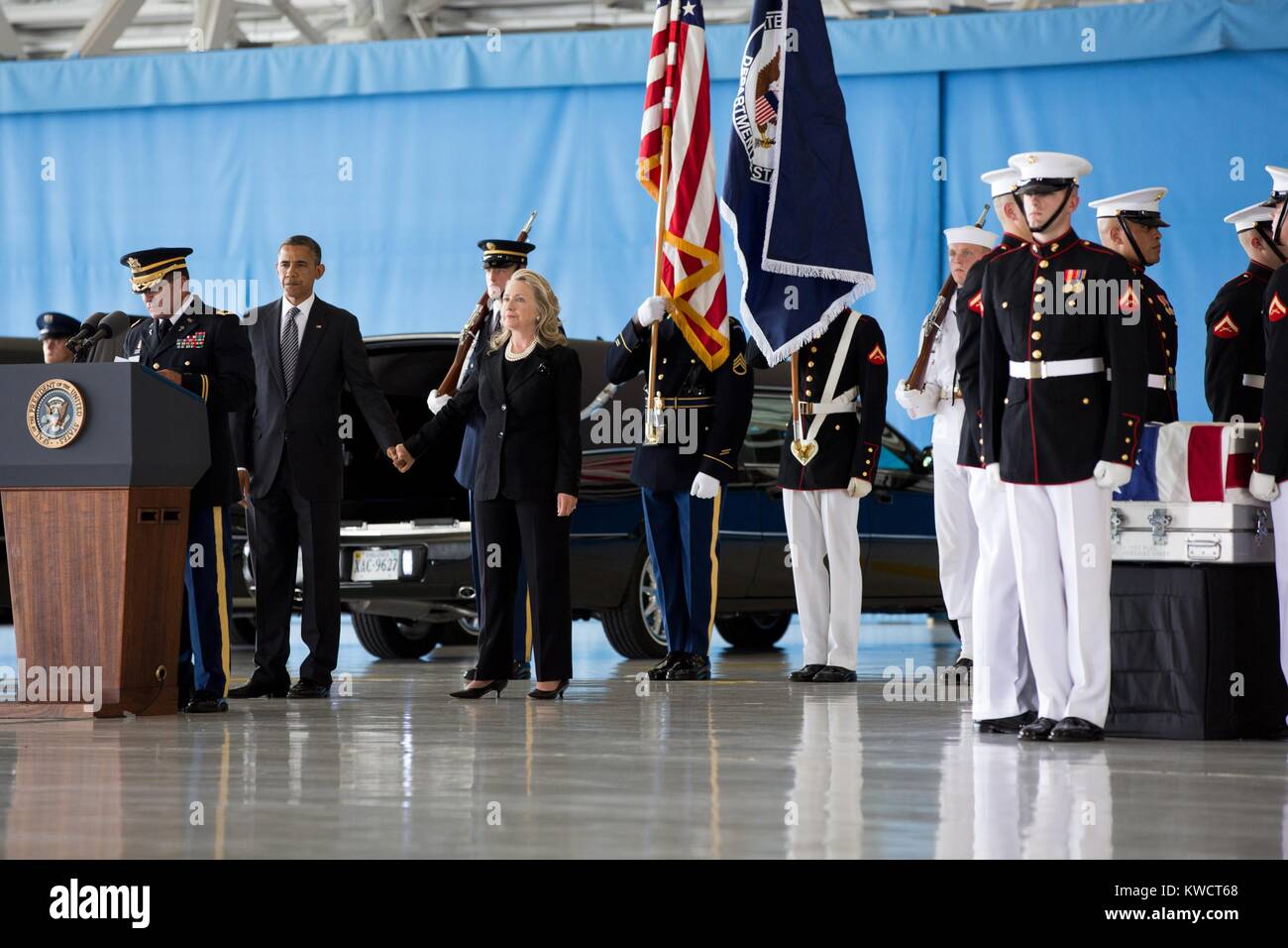 President Barack Obama hold hands with Sec. of State Hillary Rodham Clinton at Andrews Field, MD. On Sept. 14, 2012 they witnessed the transfer of remains ceremony of four Americans: J. Christopher Stevens, U.S. Ambassador to Libya; Sean Smith, Information Management Officer; and Security Personnel Glen Doherty and Tyrone Woods. All were killed in the attack on the U.S. Consulate in Benghazi, Libya. (BSLOC 2015 3 70) Stock Photo
