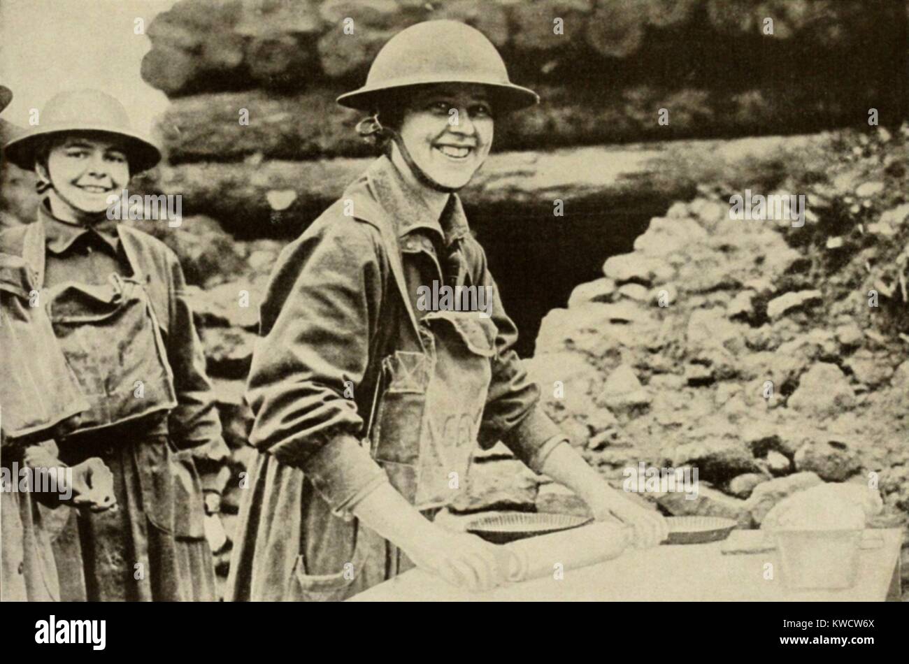 World War 1. American Salvation Army girls, with gas masks hanging from their necks, make pies for soldiers on the Western Front. 1918. (BSLOC 2013 1 194) Stock Photo