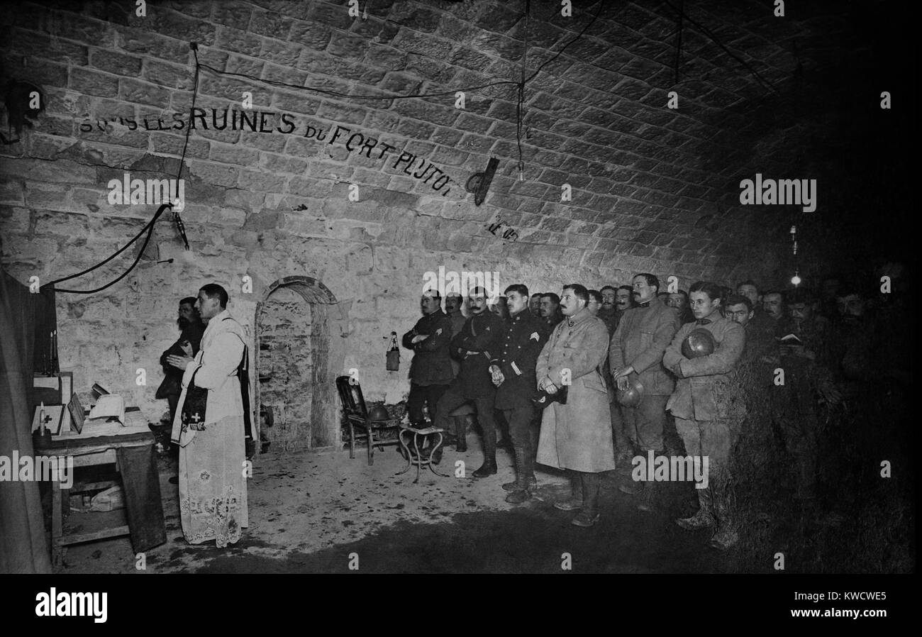 World War 1: Battle of Verdun. French soldiers at a Christmas midnight mass at Fort Douaumont, Verdun. It was one of many underground forts topped with artillery turrets built along the Meuse River in Northern France. Ca. 1916. (BSLOC 2013 1 94) Stock Photo