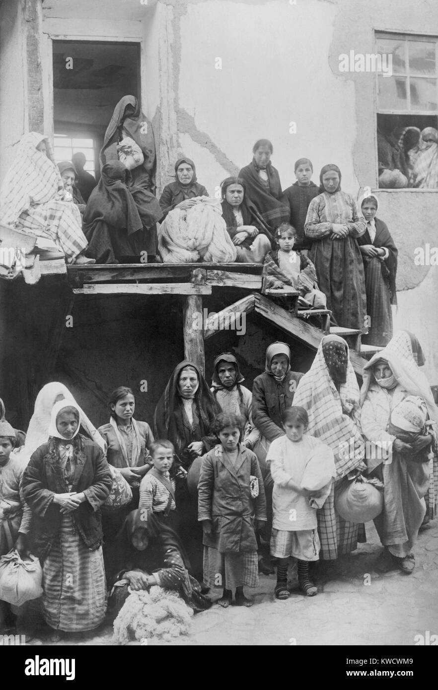 Armenian and possibly Turkish women with children, waiting for work at Marsavan (Merzifon), Turkey. May 1919. The refugees received wool to weave into cloth and clothing for orphans. The women with their faces covered may be Armenian converts to Islam (BSLOC 2017 1 164) Stock Photo