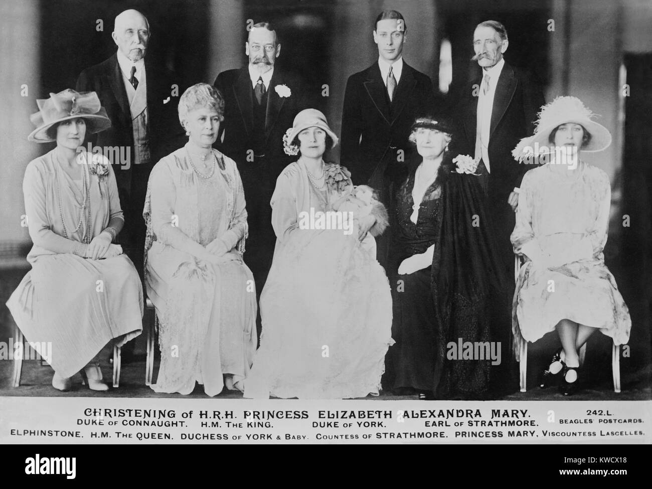 1926 christening of H.R.H. Princess Elizabeth, who became Queen Elizabeth II. Members of the British family, seated: Lady Elphinstone; Queen Mary; Duchess of York and baby Princess Elizabeth; Countess of Strathmore; Princess Mary, Viscountess Lascelles. S (BSLOC 2017 1 88) Stock Photo
