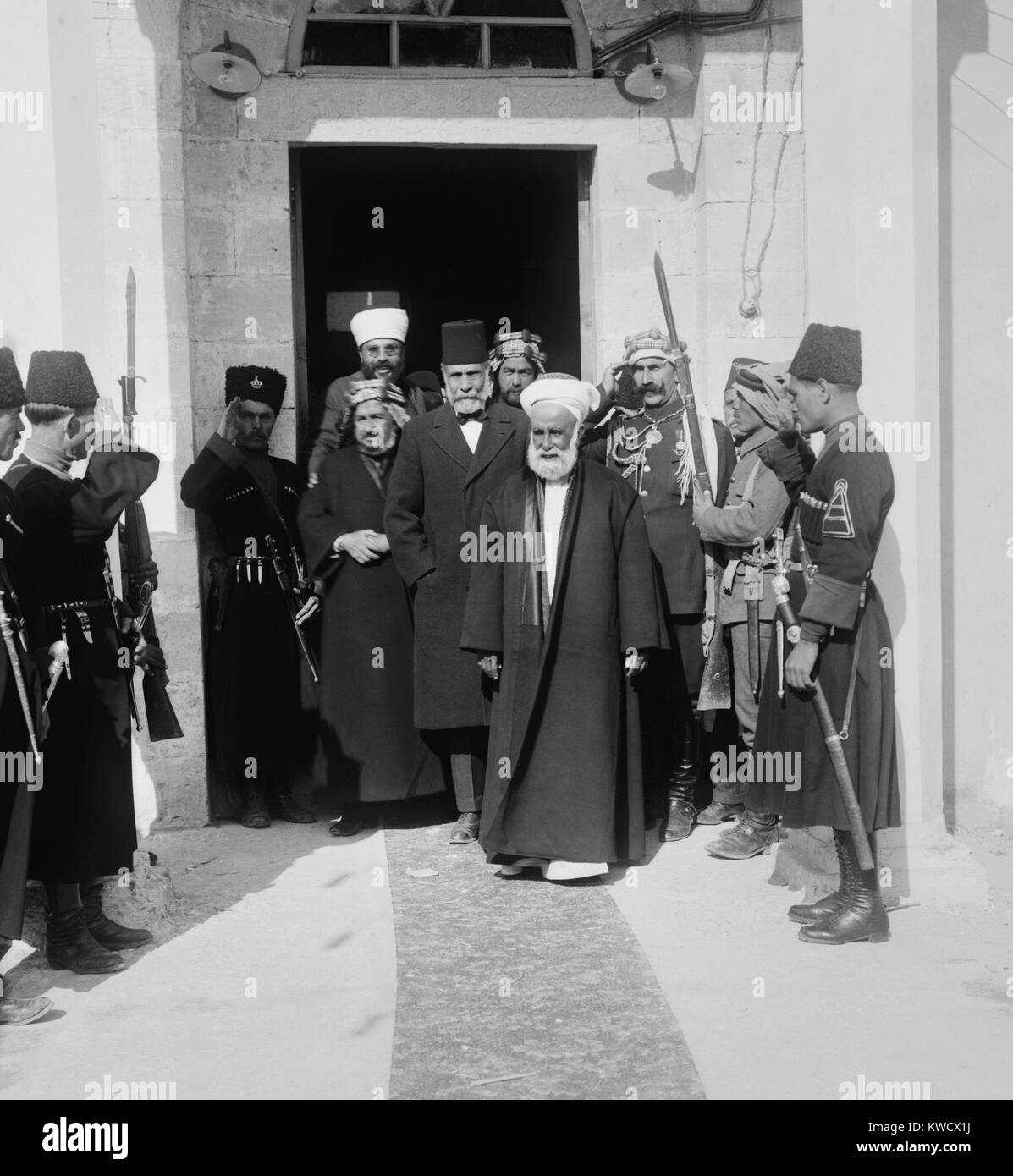 Hussein bin Ali, Sharif of Mecca, leads a group from a doorway, in Amman, Trans-Jordan, 1921. Two of his sons, Abdullah and Faisal, became the Emirs of British Mandates, Trans-Jordan and Iraq (BSLOC 2017 1 92) Stock Photo