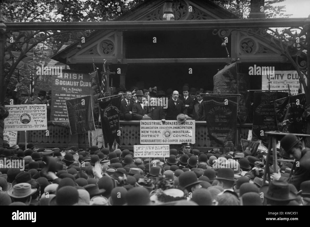 Alexander Berkman speaks in Union Square at a May Day Rally, May 1, 1908. IWW signs dominate those of other socialist groups such as: Irish Socialist Club; The Bund of Lithuania, Poland and Russia; and Jewish groups (BSLOC 2017 2 172) Stock Photo