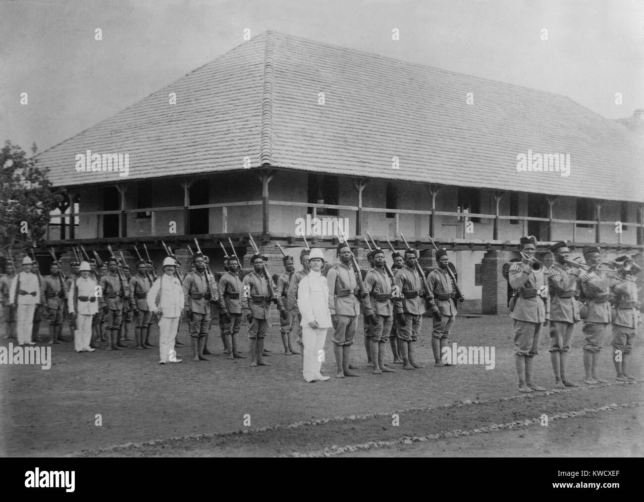 World War 1. German officers in drill formation with colonial troops at the German Government Station, Ebolowa, Cameroon, West Africa. Ca. 1915. (BSLOC 2013 1 36) Stock Photo