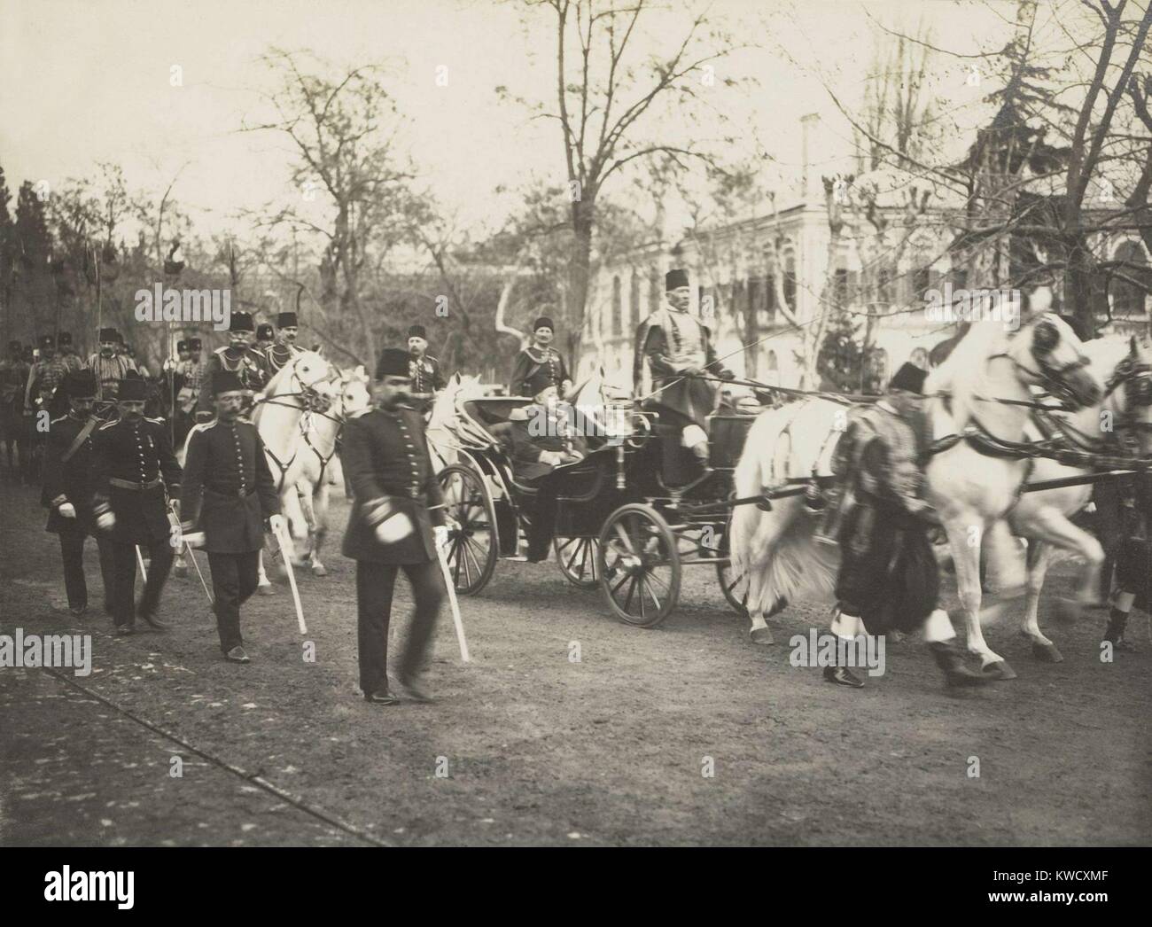 Ottoman Sultan Mehmed V in a carriage followed by the Young Turk Enver Pasha on white horse. Mehmed V, who reigned from Apr. 27, 1909 to July 3, 1918, was installed when the young Turks deposed his the less pliant brother, Sultan Abdul Hamid II (BSLOC 2017 1 103) Stock Photo