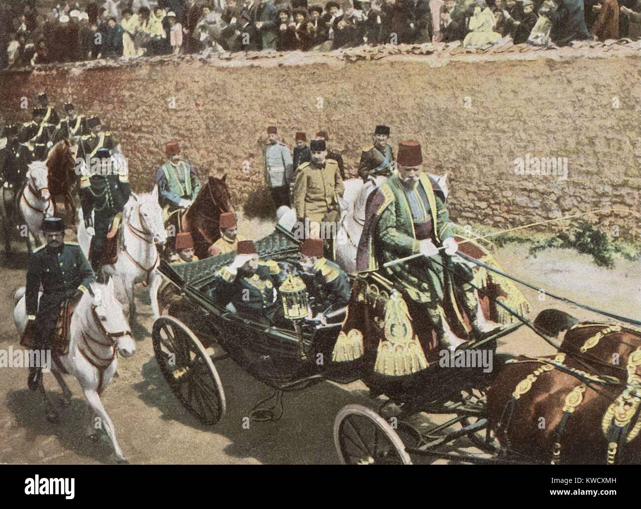 Young Turk leader, Enver Pasha, follows directly behind the carriage of Ottoman Sultan Mehmed V. They parade in Istanbul after the installation of Mehmed V, replacing his deposed brother, Sultan Abdul Hamid II (BSLOC 2017 1 104) Stock Photo