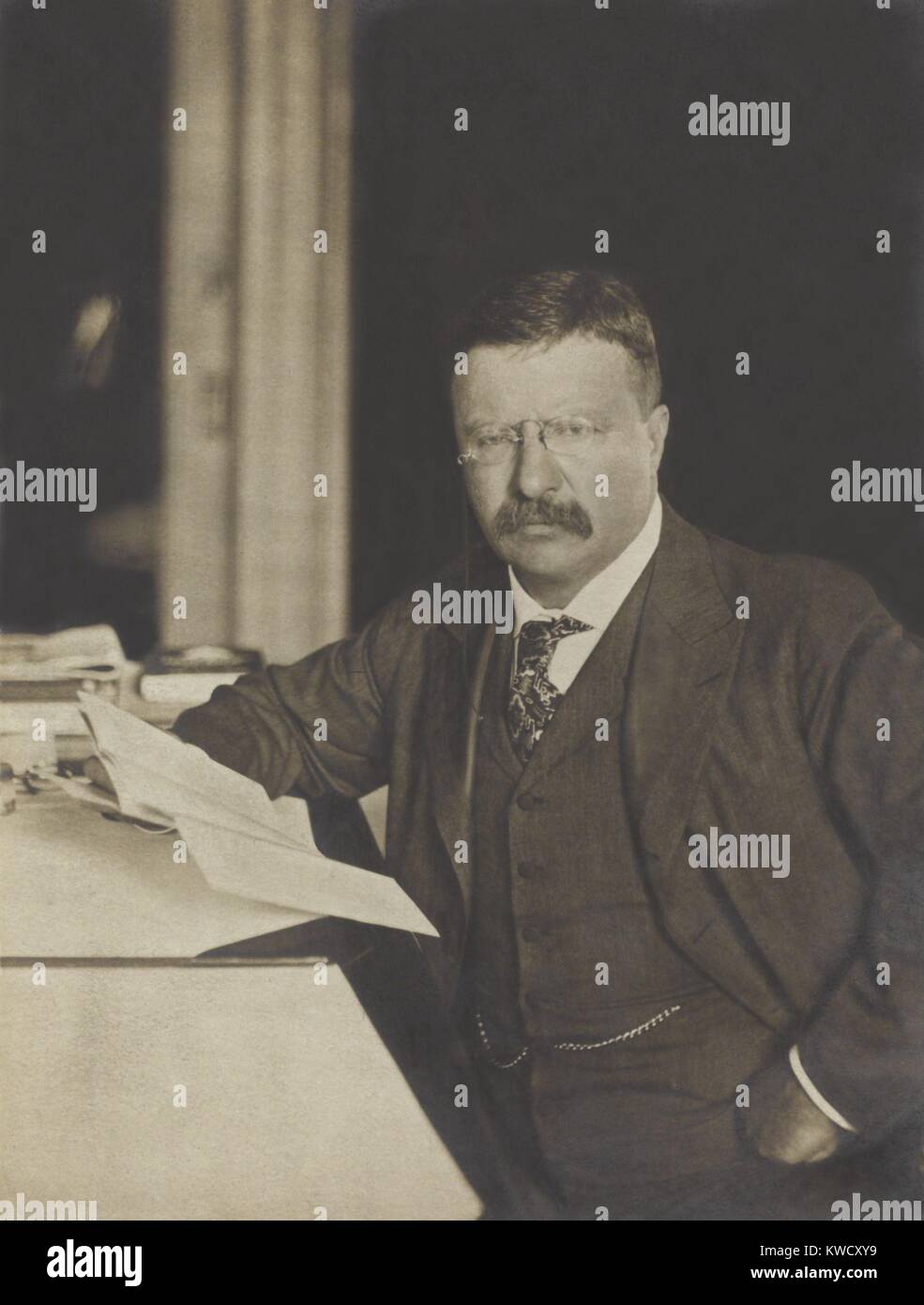 President Theodore Roosevelt, seated at his desk, holding papers, 1904 (BSLOC 2017 4 59) Stock Photo