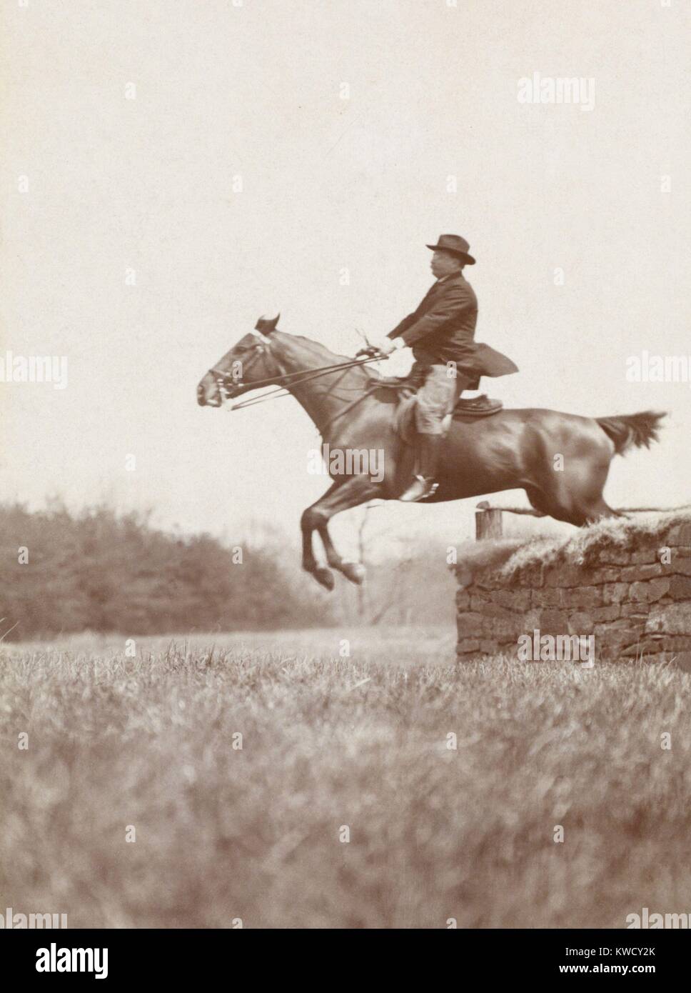 President Theodore Roosevelt, on horseback jumping over stone wall, at Chevy Chase Club, 1907. Photo by B.F. Clinedinst (BSLOC 2017 4 94) Stock Photo