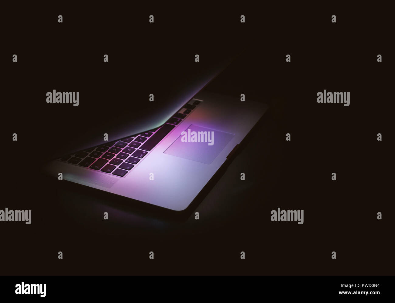 Laptop computer with open lid and glowing screen Stock Photo
