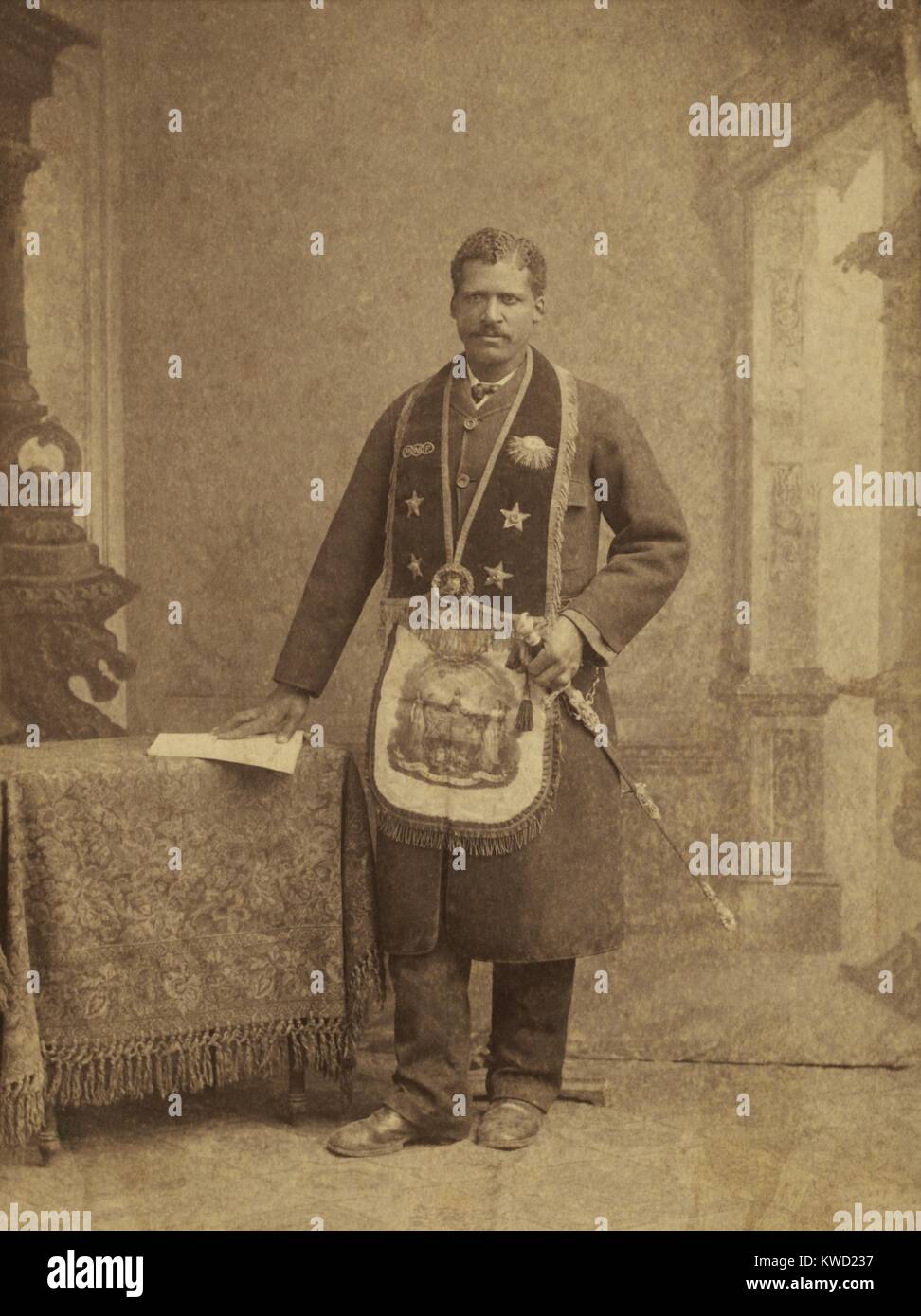 African American member of the Grand United Order of Odd Fellows, c. 1890-1900. He wears fraternal order collar and apron. His collar is embroidered with a three links symbol on the left and the sun on the right  (BSLOC 2017 20 114) Stock Photo
