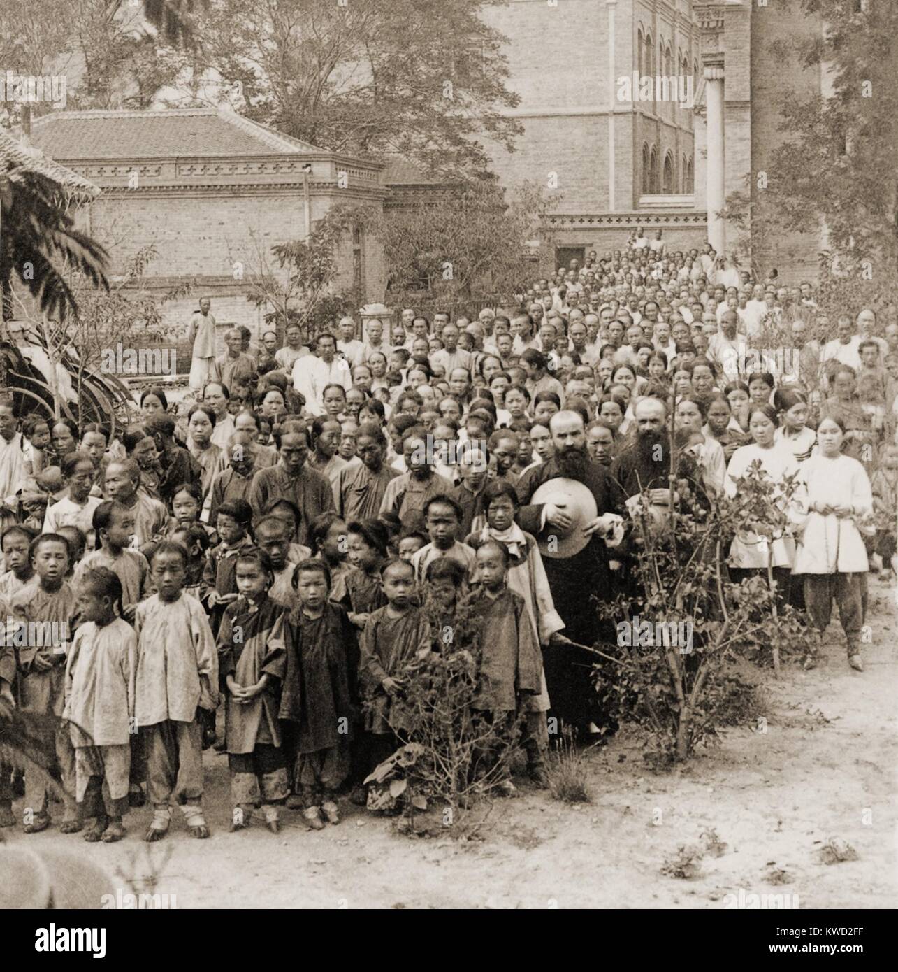 Chinese Christian refugees gathered by Father Quilloux in the Apostolic Mission, 1900. In Tianjin (Tientsin), during the Boxer Rebellion, they were sheltered during the fighting, as Christians were vulnerable to attacks by anti-foreign Boxers. The 1963 movie, 55 DAYS AT PEKING, was based on the war  (BSLOC 2017 20 3) Stock Photo