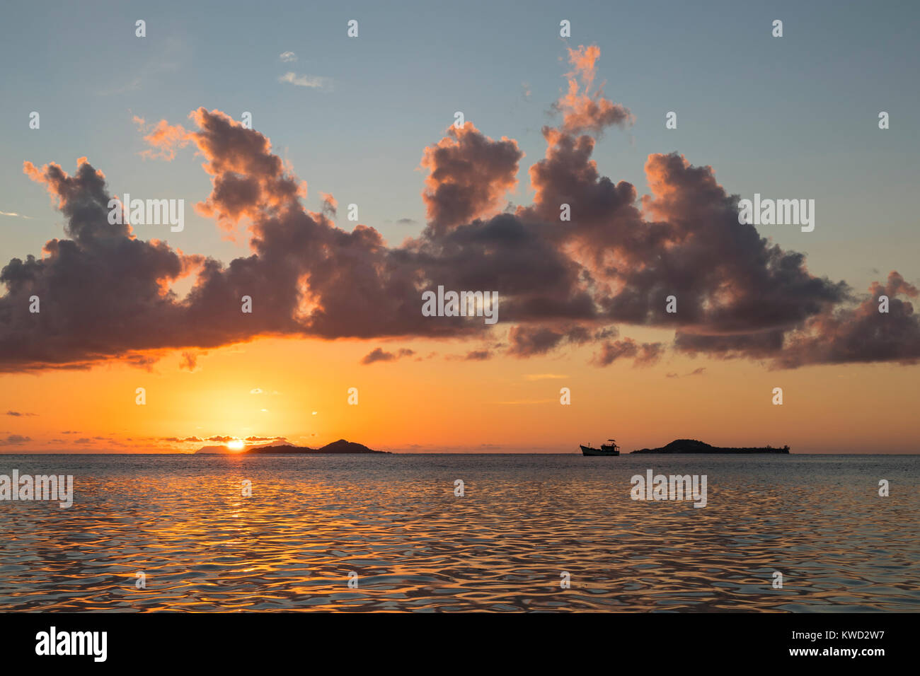 Sunset behind the islands Cousine and Cousin at Fond de l'Anse, Grande Anse, Praslin, Seychelles Stock Photo