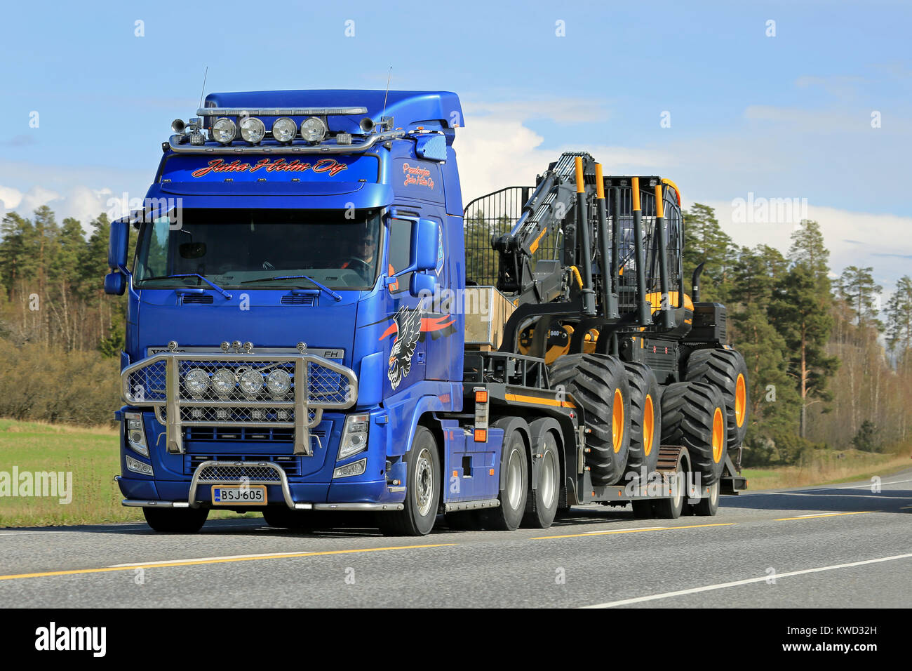 KAARINA, FINLAND - MAY 2, 2014: Volvo FH truck hauls Ponsse Scorpion forest harvester.  According to Q1 2015, Ponsses net sales amounted to EUR 91.2 m Stock Photo