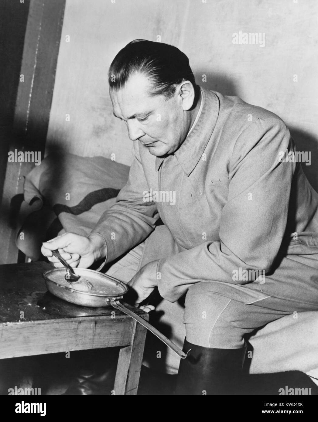 War criminal Hermann Goering eating gruel from a metal pan in prison. He was the highest ranking Nazi to be convicted at the Nuremberg Trials. Nov. 1945-Oct. 1946. (BSLOC 2014 13 2) Stock Photo