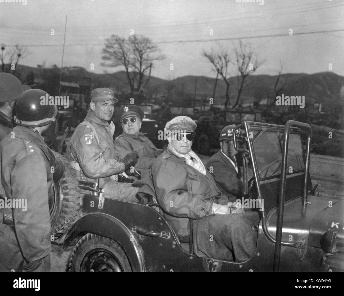 Commanders of U.N. Forces in Korea, in a jeep at a command post, Yang Yang, approximately 15 miles north of the 38th parallel, April 3, 1951. A week later Gen. Douglas MacArthur (right, sunglasses), was relieved of his command and replaced by Lt. Gen. Matthew Ridgeway (hat with 3 stars). Beside Ridgeway is Maj. Gen. Doyle Hickey. Korean War, 1950-53. (BSLOC 2014 11 136) Stock Photo