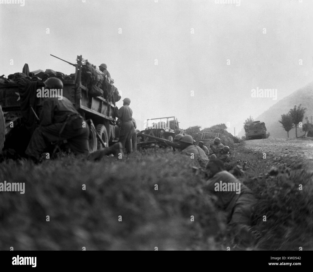 U.S. troops shelter in a ditch while under fire from North Korean invaders, during the Defense of the Pusan Perimeter. Ca. Aug. 1950. Korean War, 1950-53. (BSLOC 2014 11 18) Stock Photo