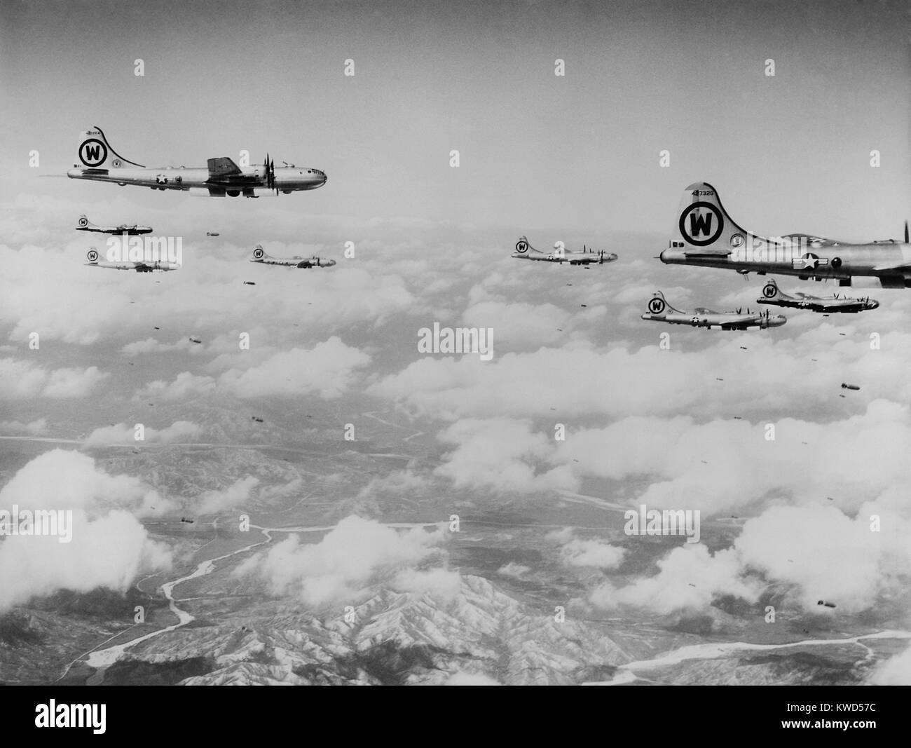 B-29s formation is shown dropping bombs over enemy territory in Korea. At first North Korea's strategic targets and industries bombed by daylight. Losses to MiG Jet fighters eventually restricted B-29s to night-only missions. Korean War, 1950-53. (BSLOC 2014 11 220) Stock Photo