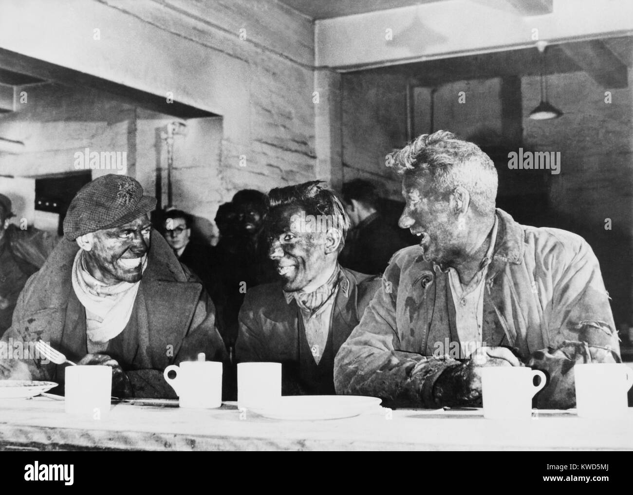 Ned Greenslade (left), champion British miner, with fellow coal miners at the canteen. He set a record by digging 120 tons of coal in a week of 6 shifts at the International Colliery, Bleangarw, Wales. Dec. 26, 1946. (BSLOC 2014 13 235) Stock Photo