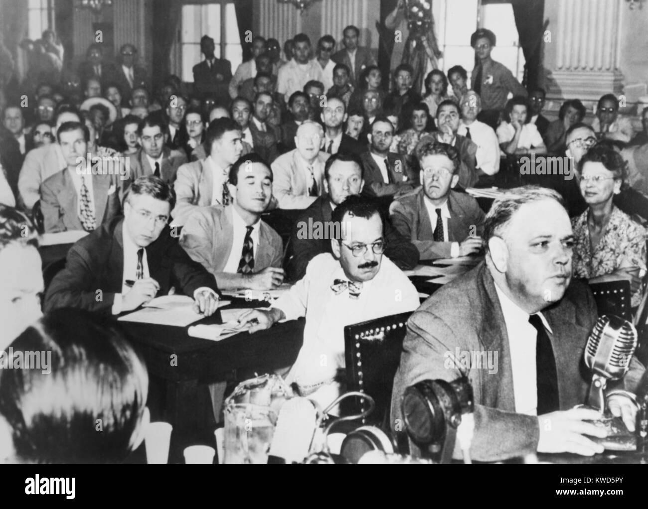Whittaker Chambers before the House Un-American Activities Committee, Aug. 25, 1948. He repeated his testimony that State Department Director, Alger Hiss, was a secret communist. Hiss is in mid-ground left, looking into camera. (BSLOC 2014 13 57) Stock Photo