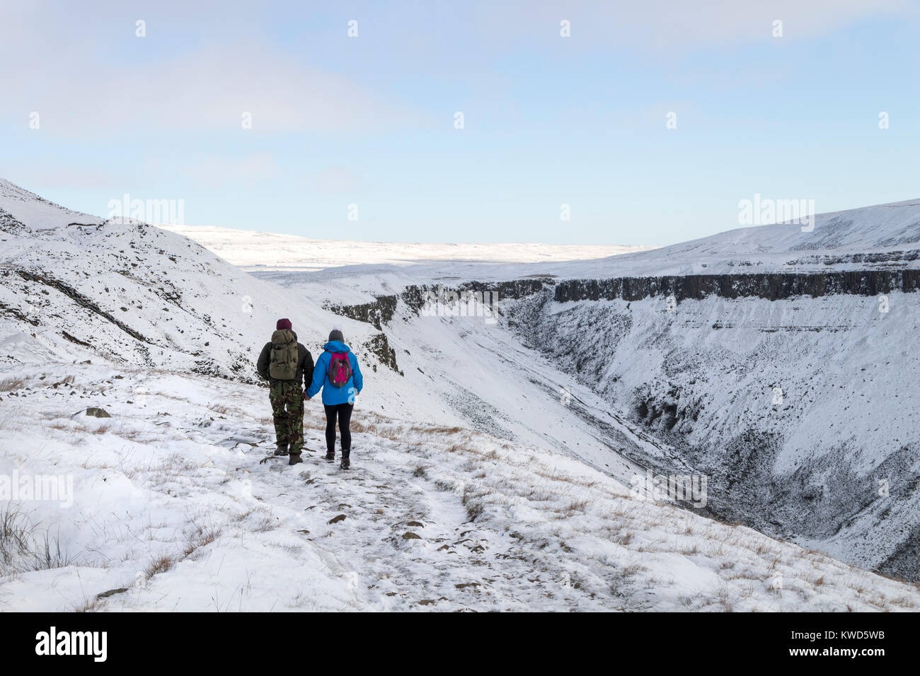 Walkers Heading towards High Cup Nick on the Pennine Way in Winter, Cumbria, UK Stock Photo