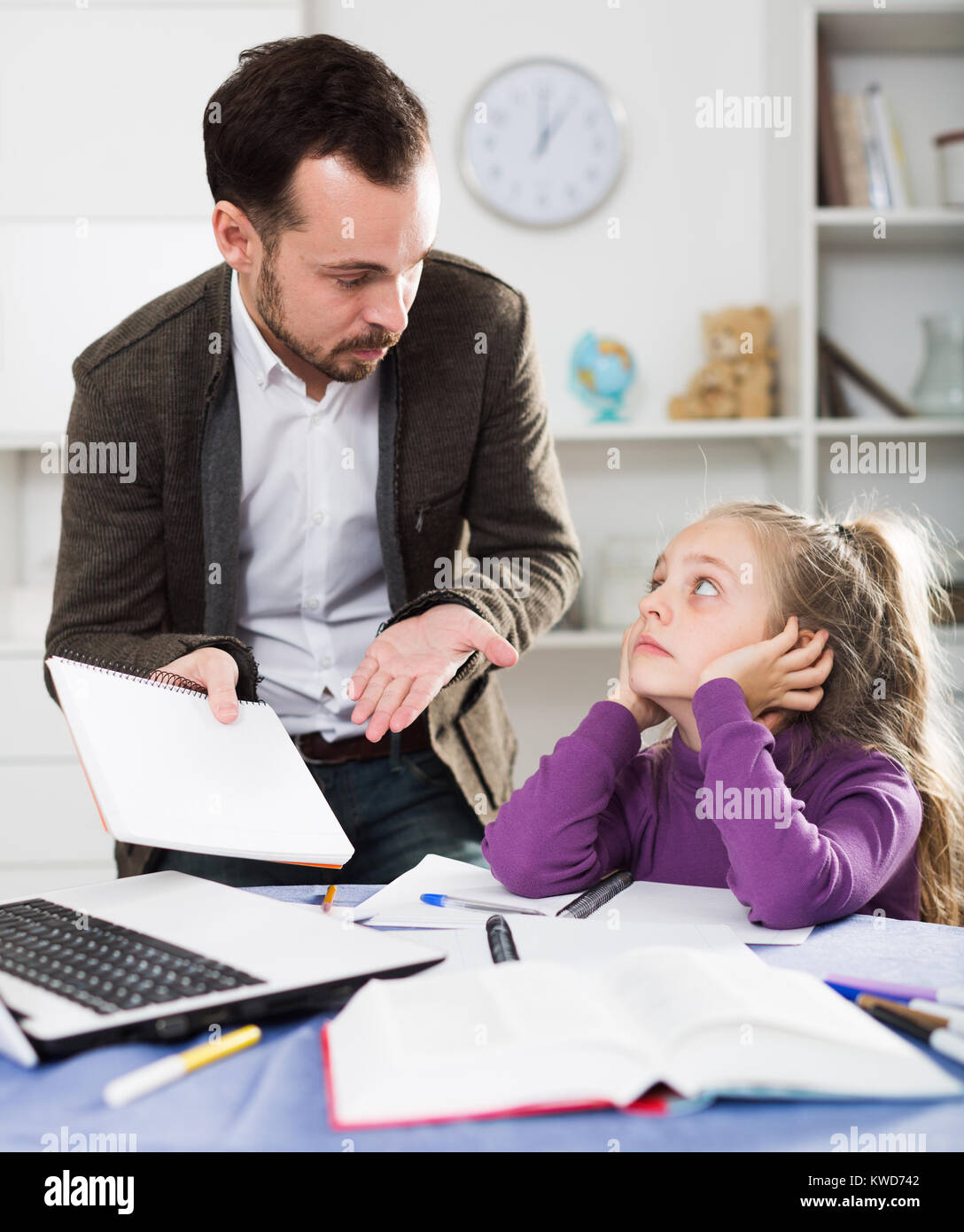 Father helping his child to do homework at home Stock Photo - Alamy