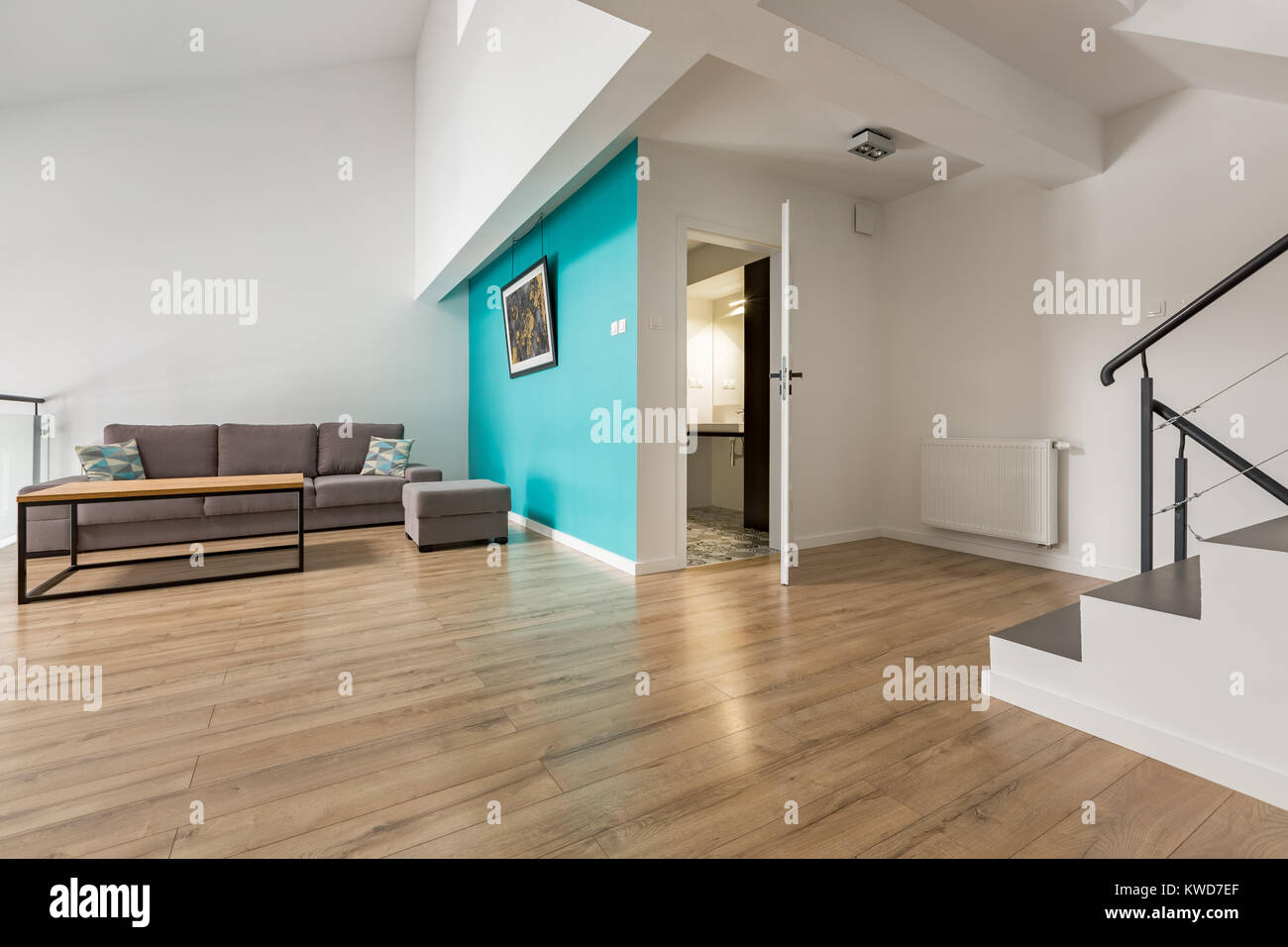 Minimalist Living Room With Stairs And Bathroom Door Open Stock