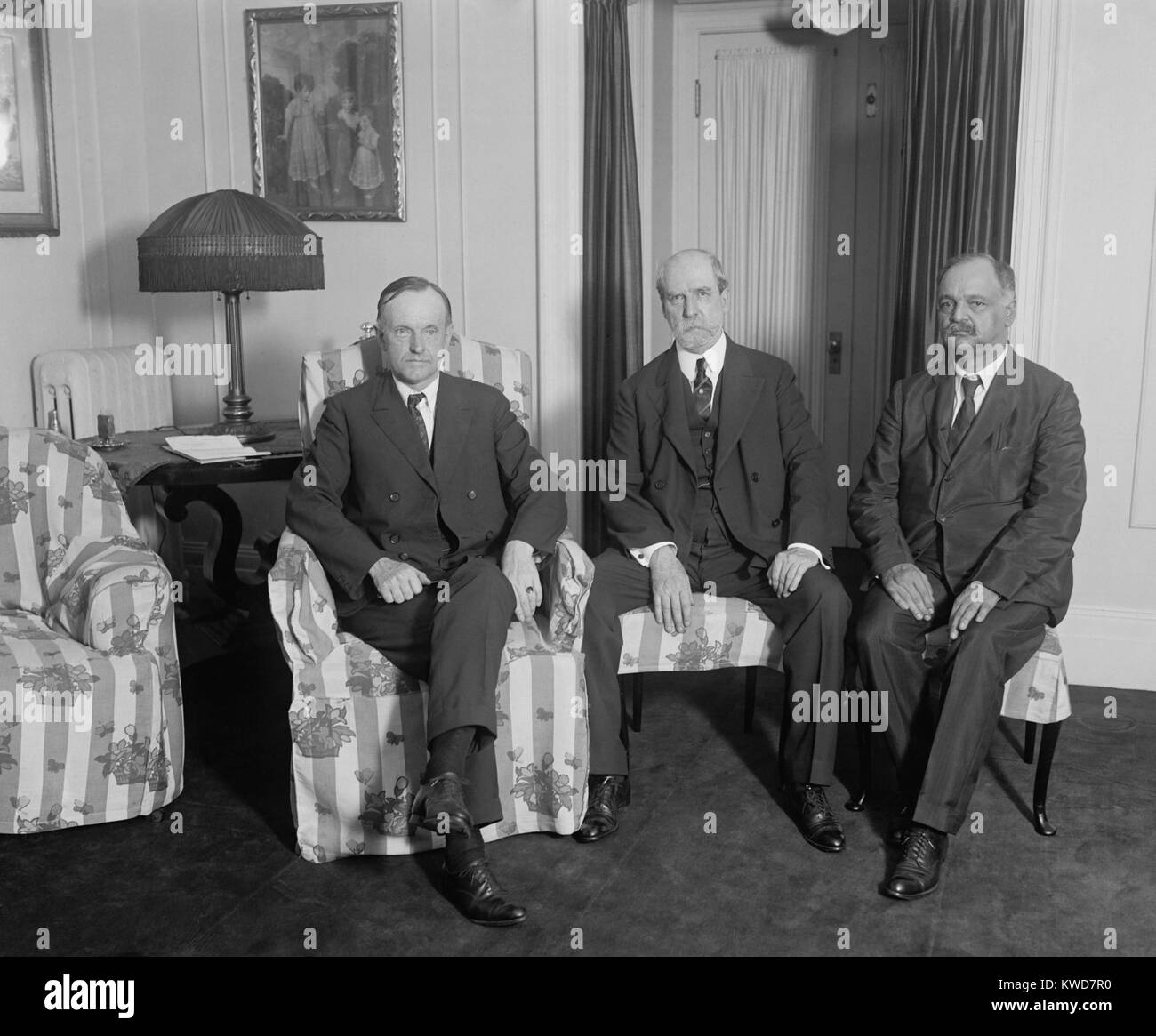 President Calvin Coolidge meeting with Charles Evans Hughes and Charles Curtis, August 3, 1923. Coolidge became President the previous day after Warren Harding died suddenly in San Francisco. Hughes was Secretary of State and Curtis was Senate Minority Whip. They met in the Coolidge family residence at the Willard Hotel, Washington D.C. (BSLOC 2015 16 13) Stock Photo