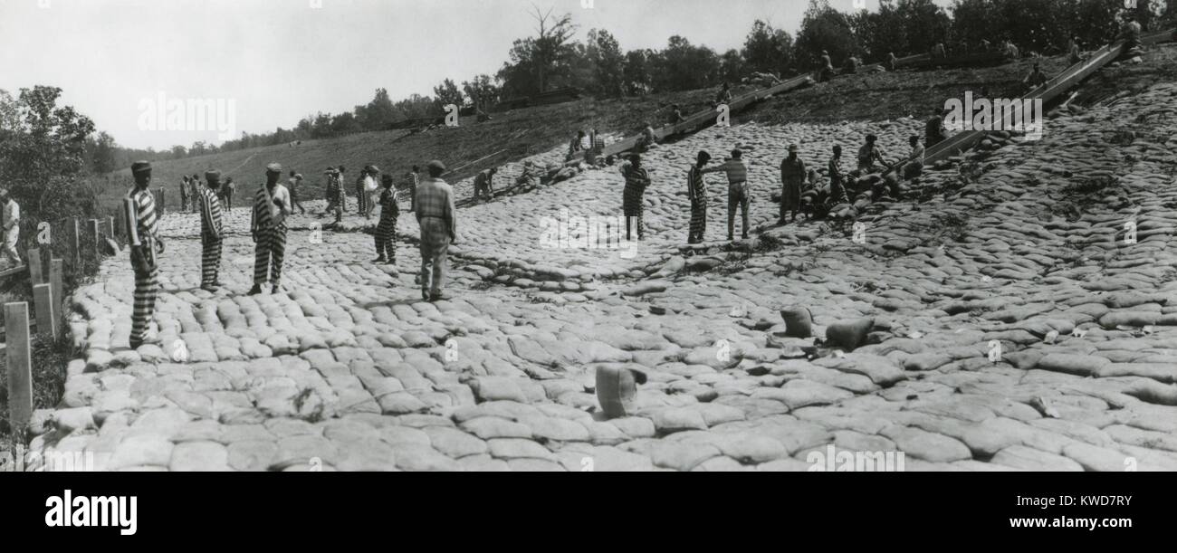 African American convicts in striped prison uniforms at forced labor in May 1922. They work on the Mississippi Fulton Slide, within the Third Mississippi River District, Vicksburg, of the U.S. Army Engineers. (BSLOC 2015 16 149) Stock Photo