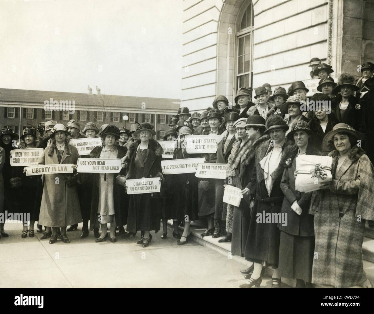 Women Suffragettes holding placards with political activist slogans in 1920. Signs read: Know Your Courts-Study Our Politicians; Liberty in Law; Law Makers Must Not Be Law Breakers; Character in Candidates; etc. (BSLOC 2015 16 190) Stock Photo
