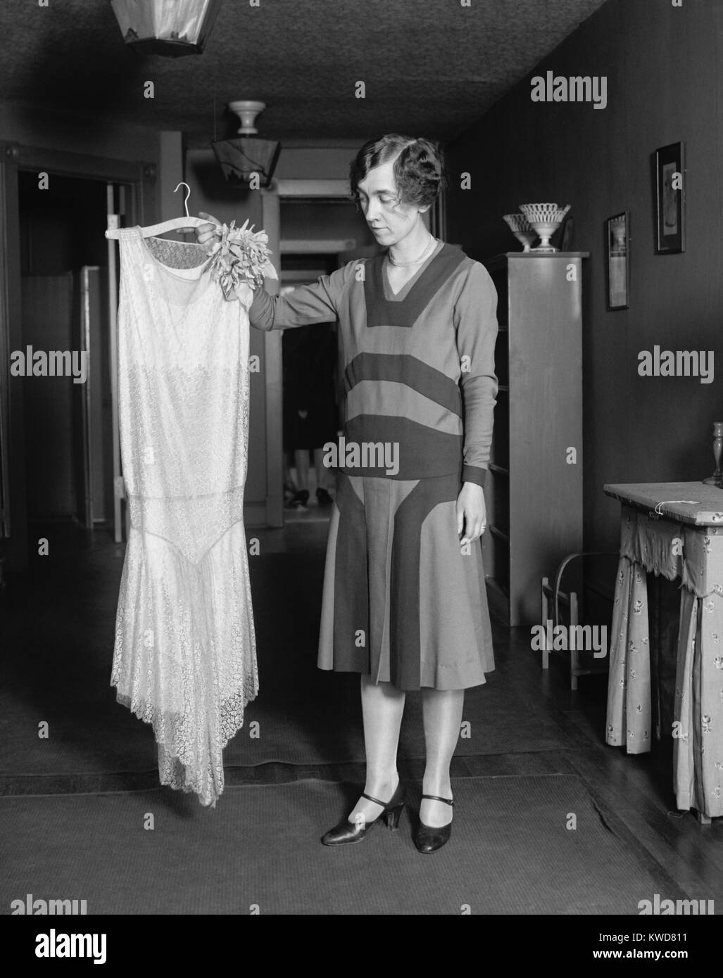 Young women quizzically evaluating new dress, May 14, 1925. (BSLOC 2015 16 248) Stock Photo