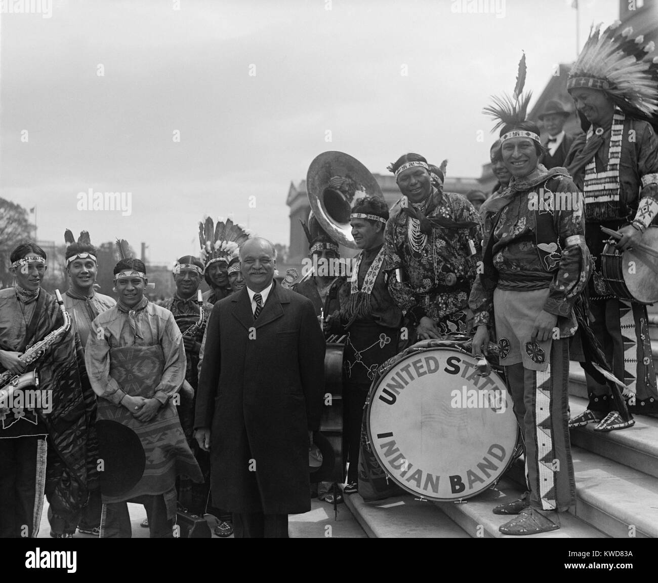 Vice President Charles Curtis on the Capitol steps with the United States Indian Band. April 26, 1929. The VP was a Kaw Nation Native American, and spent much of his childhood with his grandparents on the Kaw reservation. He lived with his White paternal grandparents while attending Topeka High School. (BSLOC 2015 16 64) Stock Photo