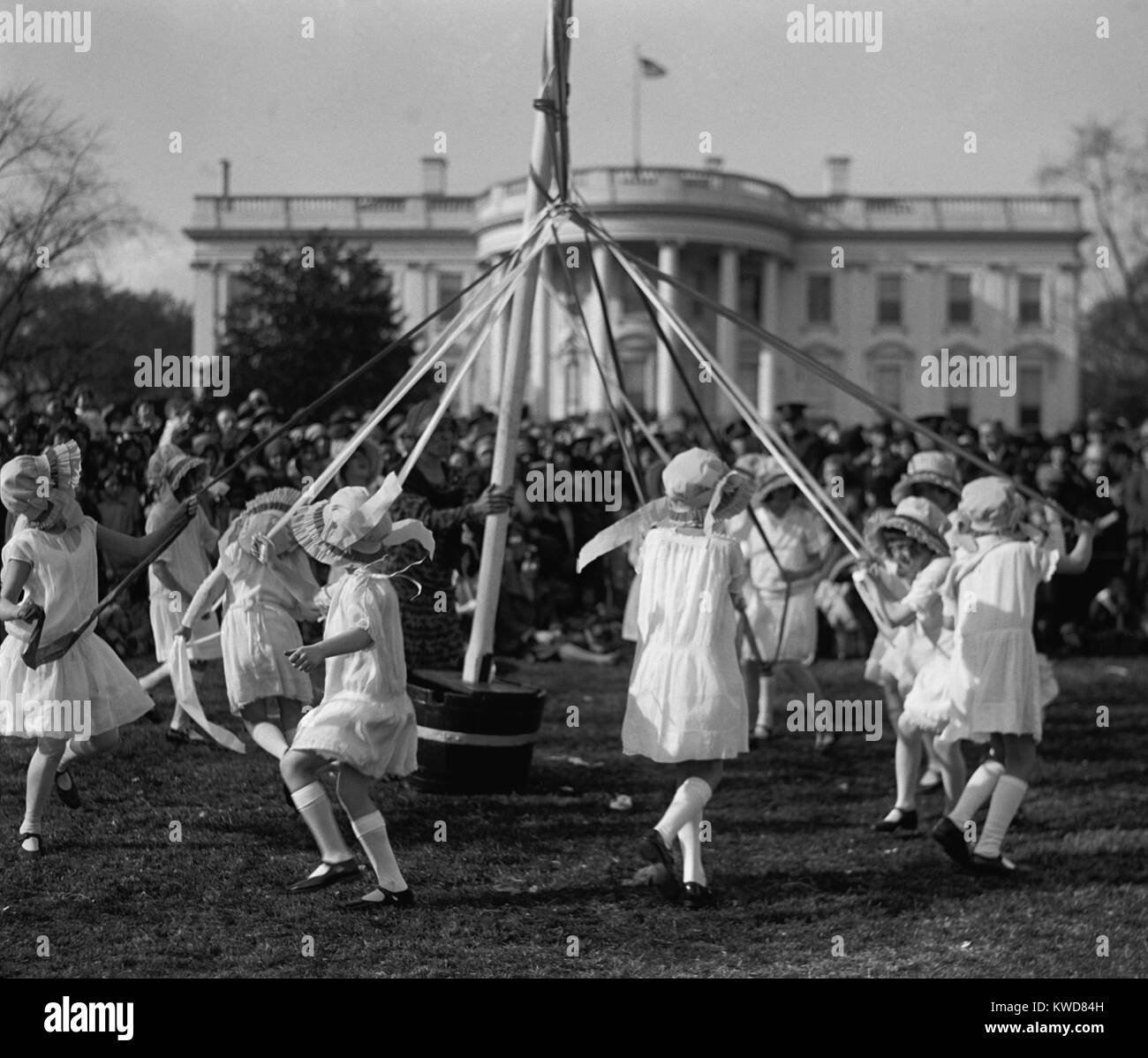 Children dance around a maypole at the White House Easter Celebration on April 1, 1929. First Lady Lou Hoover replaced the Easter Egg Roll with Folk Dancing, because she disliked egg stench that followed. (BSLOC 2015 16 88) Stock Photo